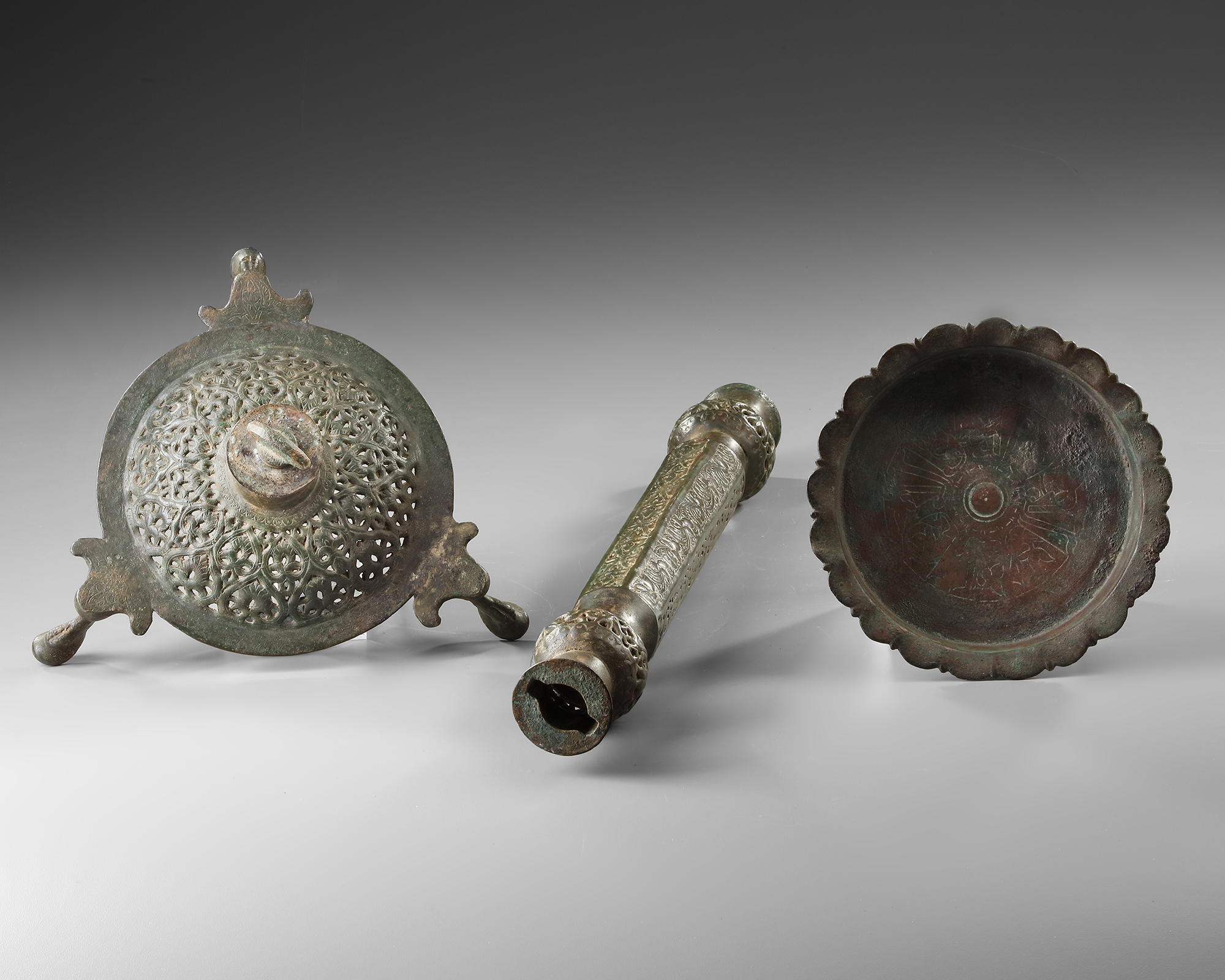 AN ISLAMIC OPENWORK OIL LAMP AND STAND, KHORASAN, PERSIA, 12TH CENTURY