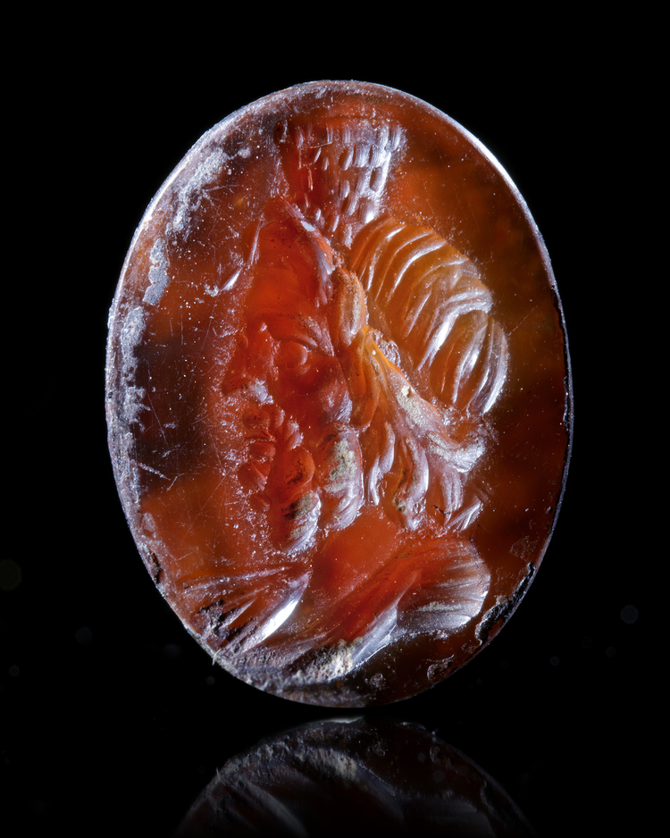 A ROMAN INTAGLIO OF SERAPIS IN CARNELIAN, 1ST CENTURY AD