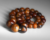 A STRING OF BEADS, 20TH CENTURY