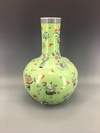 A Chinese green-ground famille rose appliqué decorated bottle vase