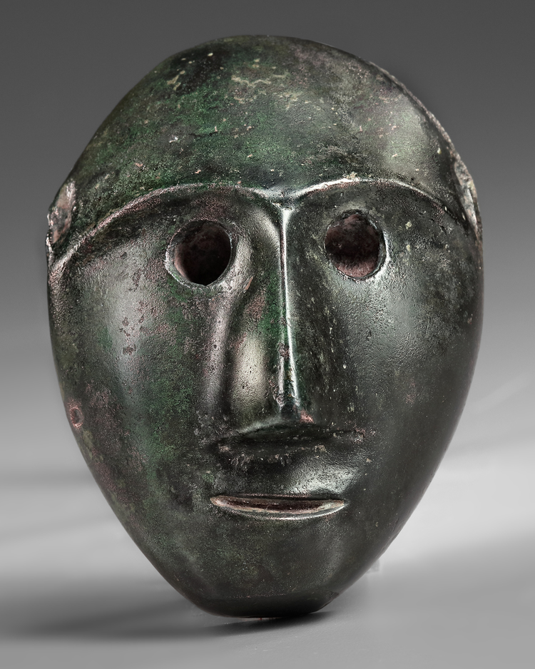 A WESTERN PERSIAN BRONZE MALE MASK, CIRCA 1200-800 B.C.