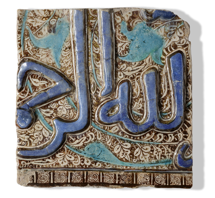 A KASHAN MOULDED LUSTRE AND COBALT BLUE POTTERY TILE,  CENTRAL IRAN, 13TH CENTURY