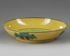 A SMALL CHINESE YELLOW GLAZED PLATE WITH DRAGONS, 19TH-20TH CENTURY