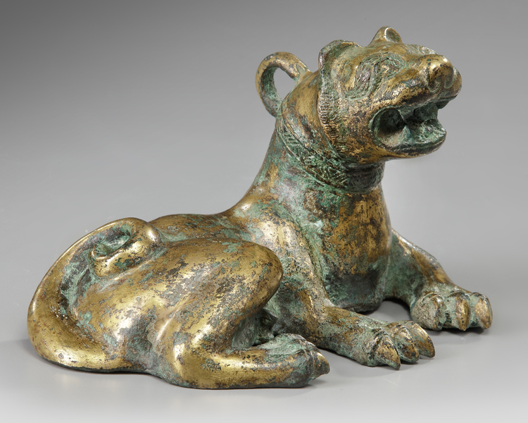 A GILT BRONZE FIGURE OF A BUDDHIST LION, YUAN/MING DYNASTY, CIRCA 14TH-15TH CENTURY