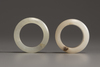 A Chinese white jade archers ring and a very pale celadon jade archers ring
