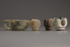 Three Chinese jade and agate 'hand'-shaped pipe bowl holders and a carved hardstone coupe
