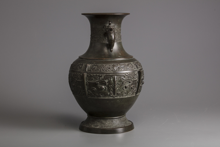 A bronze vase with elephant handles