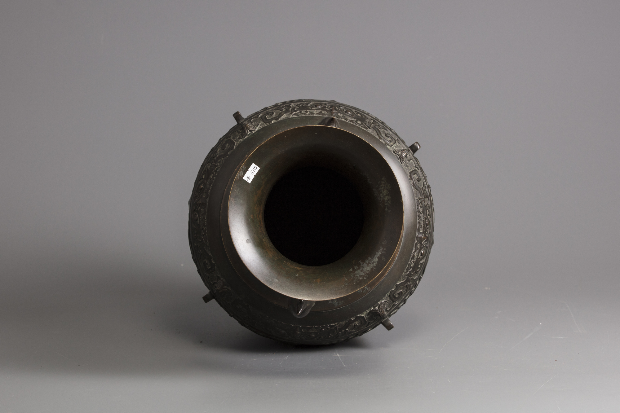 A bronze vase with elephant handles