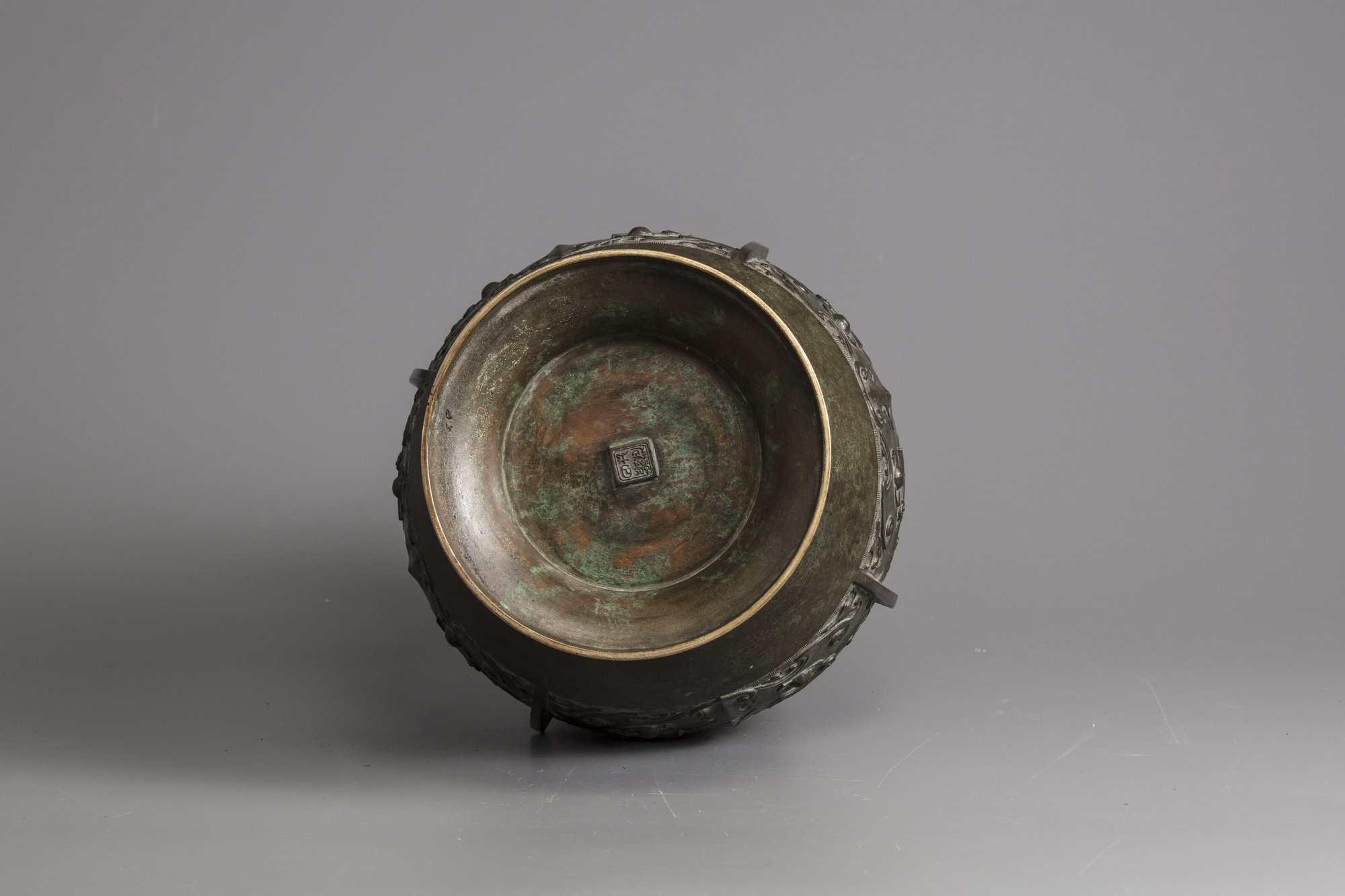 A bronze vase with elephant handles