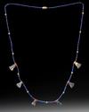 AN EGYPTIAN LOTUS FLOWER LAPIS LAZULI AMULET NECKLACE, CIRCA 1550-1570 B.C.