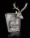 AN ACHAEMENID SILVER PLAQUE WITH SEATED STAG, CIRCA 550-500 B.C.