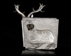 AN ACHAEMENID SILVER PLAQUE WITH SEATED STAG, CIRCA 550-500 B.C.
