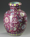 A CHINESE FAMILLE ROSE RUBY GROUND VASE, 19TH/20TH CENTURY