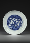 A CHINESE BLUE AND WHITE INCISED DECORATED DISH, WANLI PERIOD (1573-1619)
