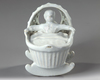 A WHITE DELFT MODEL OF A BABY IN A CRADLE, END OF 18TH CENTURY