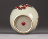 A Chinese celadon-ground 'nine peaches' ovoid jar