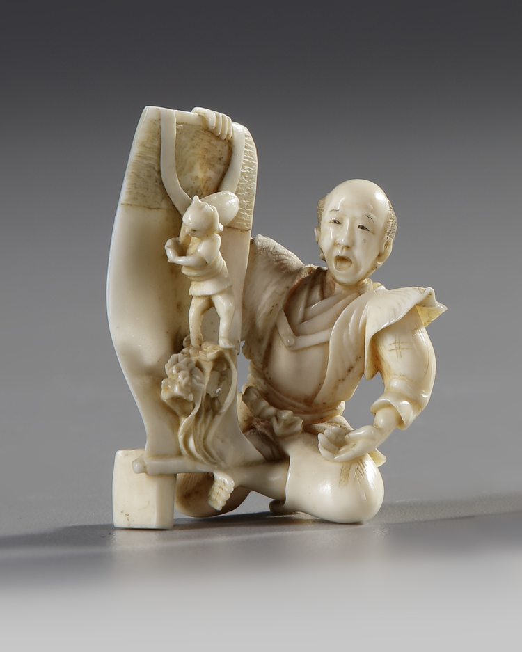 A JAPANESE OKIMONO OF A DREAMING MAN HOLDING A SCROLL, 19TH CENTURY