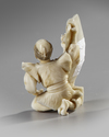 A JAPANESE OKIMONO OF A DREAMING MAN HOLDING A SCROLL, 19TH CENTURY