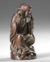 A CHINESE WOOD CARVING OF A LOHAN,20TH CENTURY