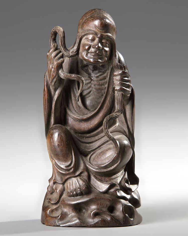 A CHINESE WOOD CARVING OF A LOHAN, 20TH CENTURY