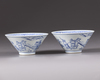 A pair of blue and white conical shaped bowls