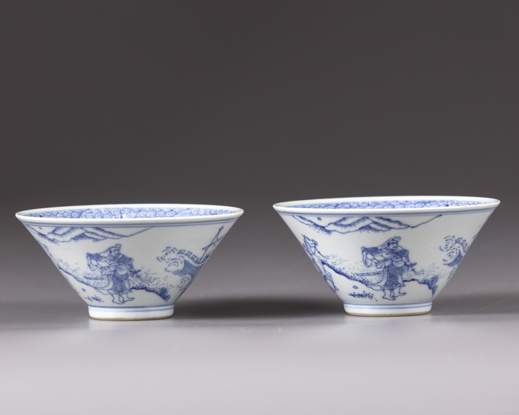 A pair of blue and white conical shaped bowls