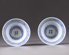 A pair of blue and white conical shaped bowls