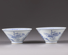 A pair of blue and white conical shaped bowls