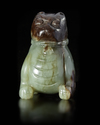 A CHINESE SPINACH CARVED JADE FU DOG, MING DYNASTY (1368-1644)