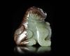 A CHINESE SPINACH CARVED JADE FU DOG, MING DYNASTY (1368-1644)