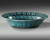 A RAQQA TURQUOISE-GLAZED POTTERY DISH, SYRIA, EARLY 13TH CENTURY