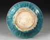 A RAQQA TURQUOISE-GLAZED POTTERY DISH, SYRIA, EARLY 13TH CENTURY