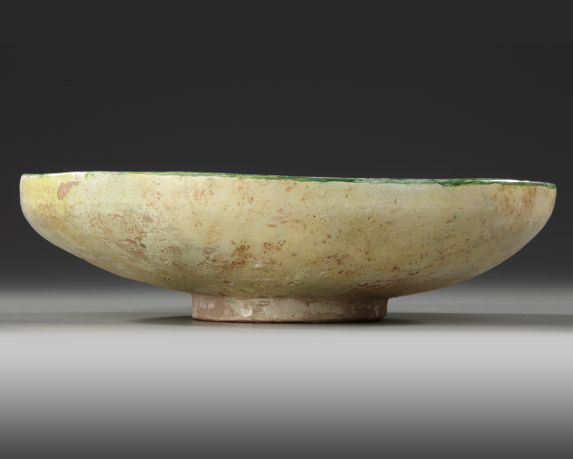 A NISHAPUR BUFFWARE POTTERY BOWL, PERSIA, 10TH CENTURY