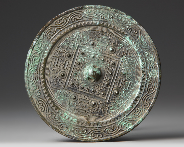 A CHINESE CIRCULAR 'TLV' BRONZE MIRROR,  XIN-EARLY EASTERN HAN DYNASTY, 1ST CENTURY