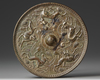 A CHINESE BRONZE CIRCULAR MIRROR WITH ANIMALS, SONG DYNASTY (960-1279) OR LATER