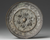 A CHINESE CIRCULAR "LIONS AND BIRDS" BRONZE MIRROR, TANG DYNASTY (618-907 AD)