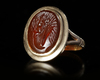 A CARNELIAN ROMAN INTAGLIO OF AN EAGLE'S HEAD, 1ST CENTURY AD