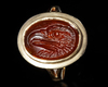 A CARNELIAN ROMAN INTAGLIO OF AN EAGLE'S HEAD, 1ST CENTURY AD