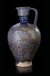 * A MONUMENTAL LAJVARDINA POTTERY JUG, ILKHANID PERSIA, 13TH CENTURY