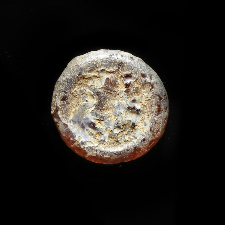 AN EARLY ISLAMIC GLASS WEIGHT OF HALF DIRHAM