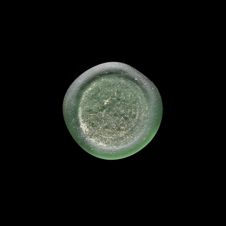 AN EARLY ISLAMIC GLASS WEIGHT OF DIRHAM