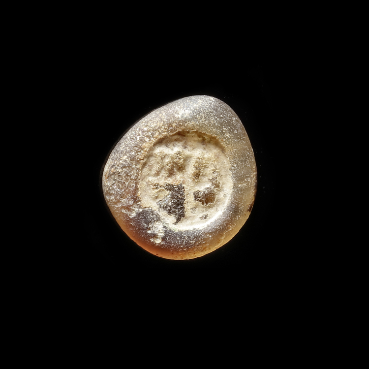 AN EARLY ISLAMIC GLASS WEIGHT OF HALF DIRHAM