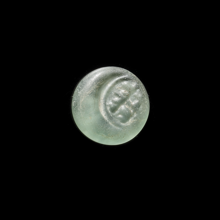 AN EARLY ISLAMIC GLASS WEIGHT OF HALF DIRHAM