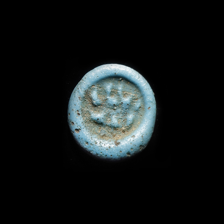 AN EARLY ISLAMIC GLASS WEIGHT OF QUARTER DINAR