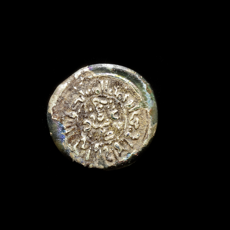 A FATIMID GLASS WEIGHT OD DIRHAM, AL-MUSTANSIR BI-ALLAH (AH 427-487 / 1036-1094 AD),