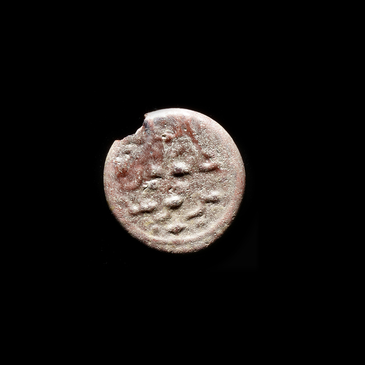 AN EARLY ISLAMIC GLASS WEIGHT OF HALF DINAR