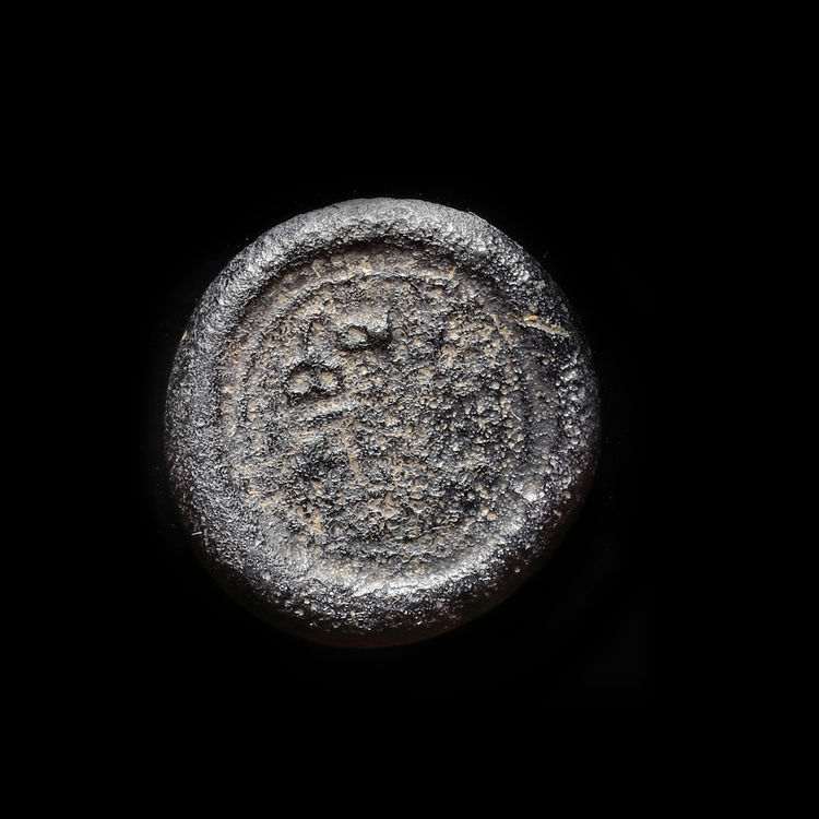 AN EARLY ISLAMIC GLASS WEIGHT OF DIRHAM