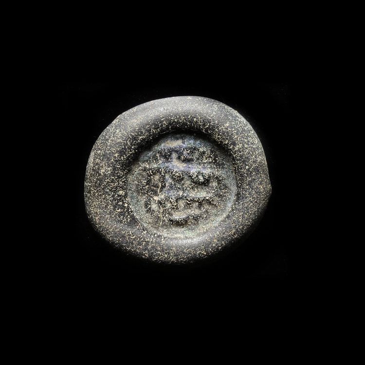 AN ABBASID GLASS WEIGHT OF DOUBLE DIRHAM, BAGHDAD AL-NASIR LI-DIN ALLAH, 576-622 AH/1180-1225 AD