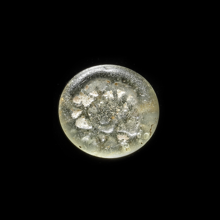 AN EARLY ISLAMIC GLASS WEIGHT OF HALF DIRHAM, 10TH-11TH CENTURY