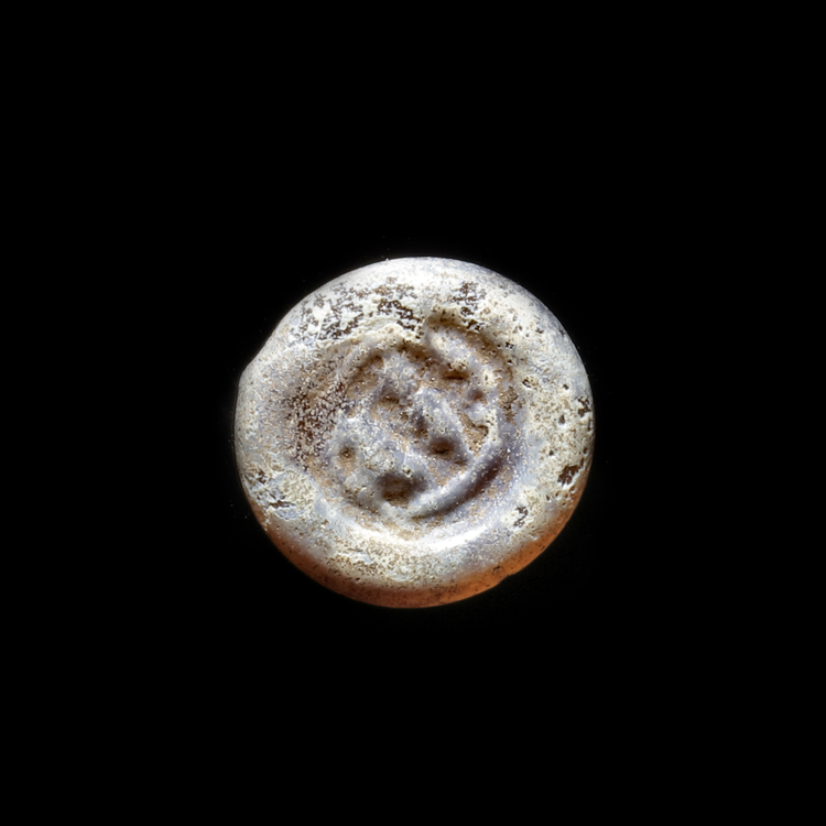 AN EARLY ISLAMIC GLASS WEIGHT OF HALF DIRHAM,10TH-11TH CENTURY